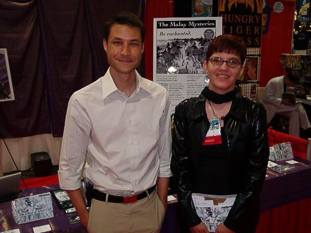 Jai Sen (left, white shirt, looking like a prince) and Barb (right, looking like a goth pixie) at a con
